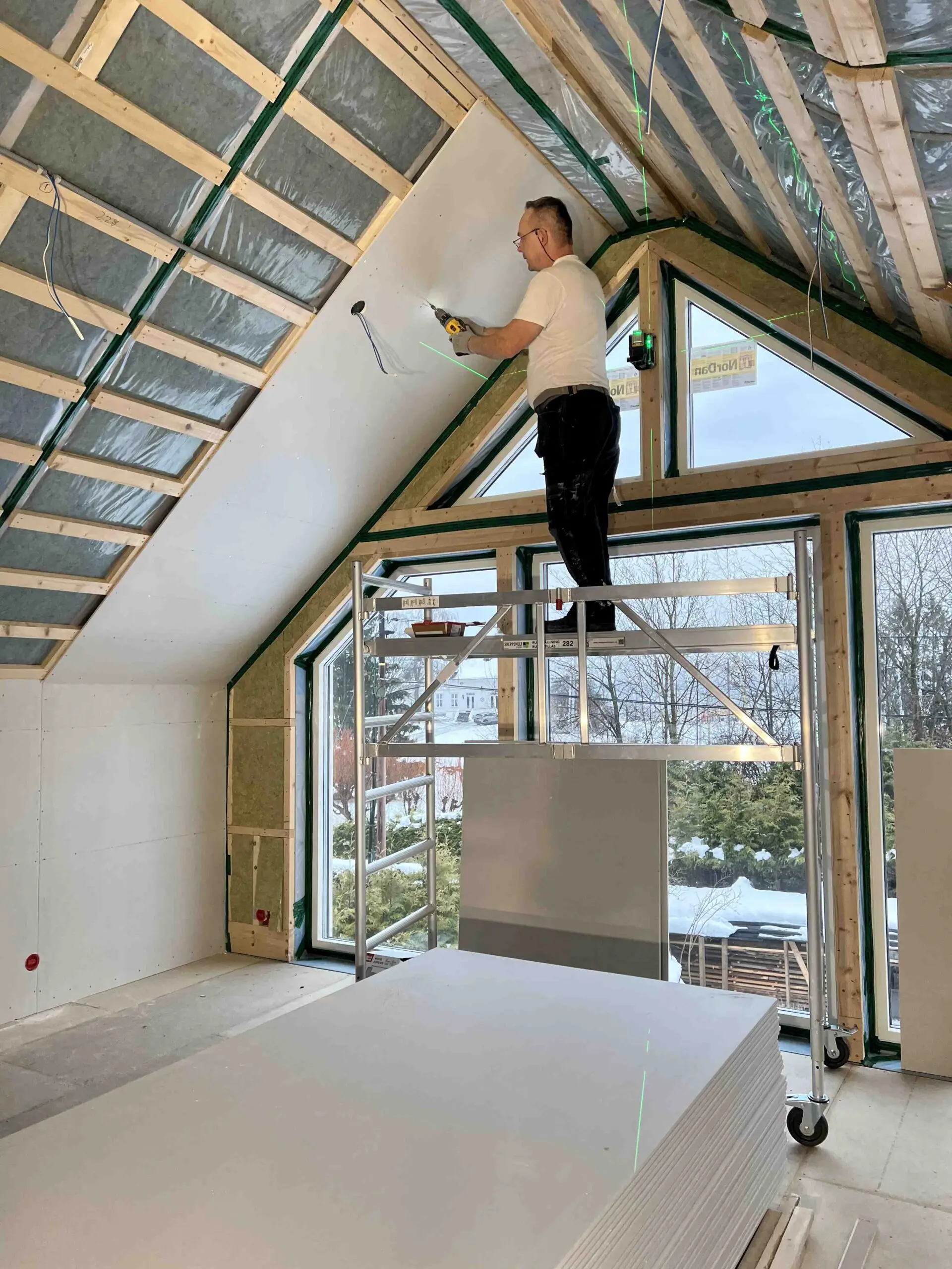 Loft conversion in progress with an insulated sloping ceiling